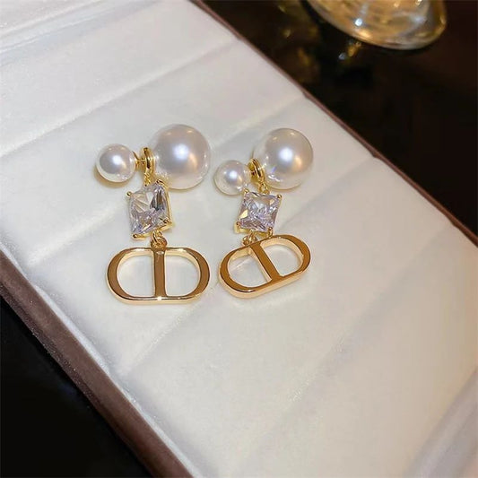 Branded pearl and statement earrings